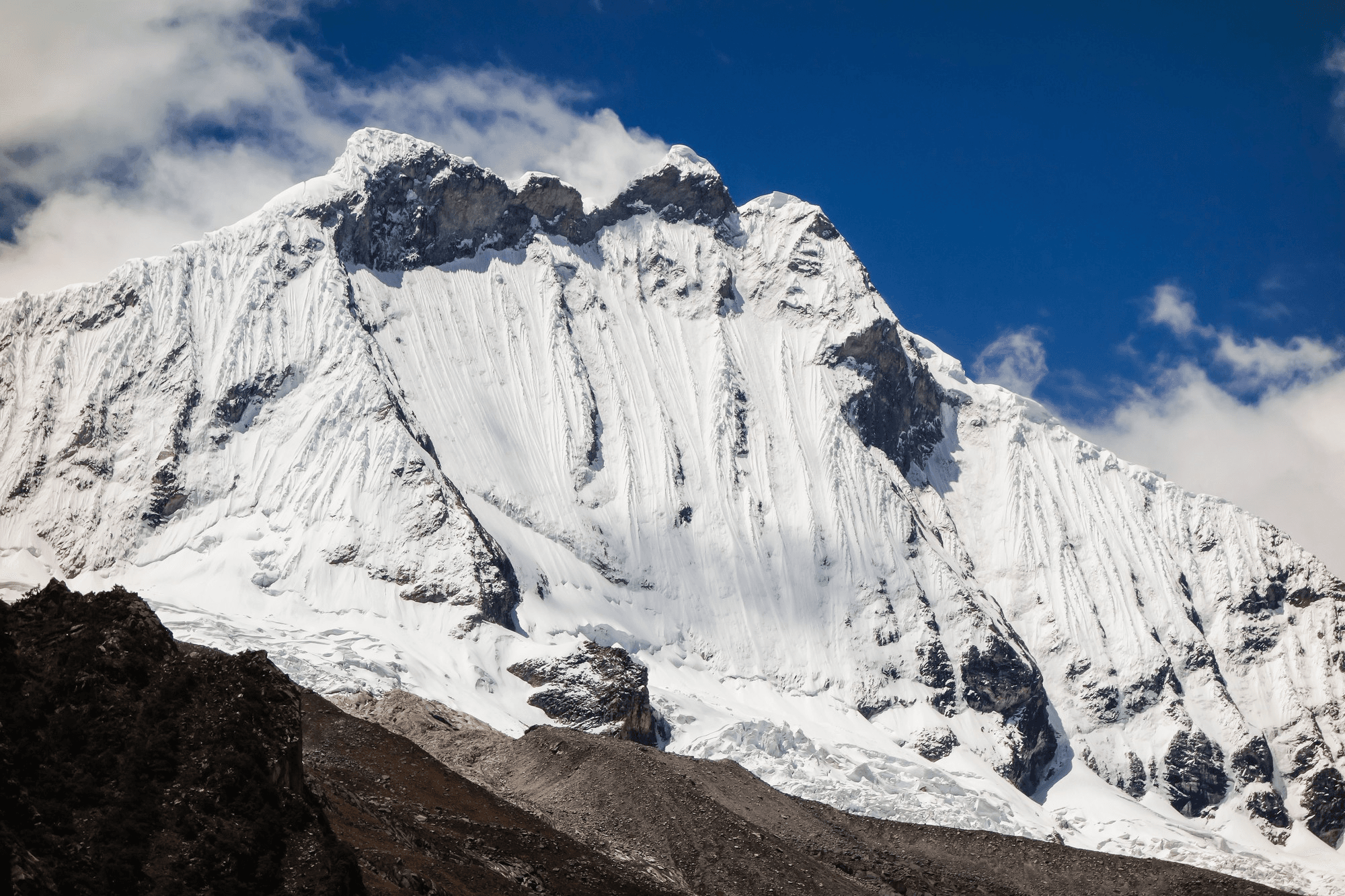 Snow-covered Khumbu mountain landscape under a blue sky